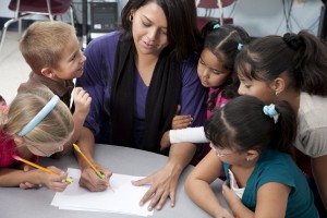 Real People: Teacher with Children in School Education Learning